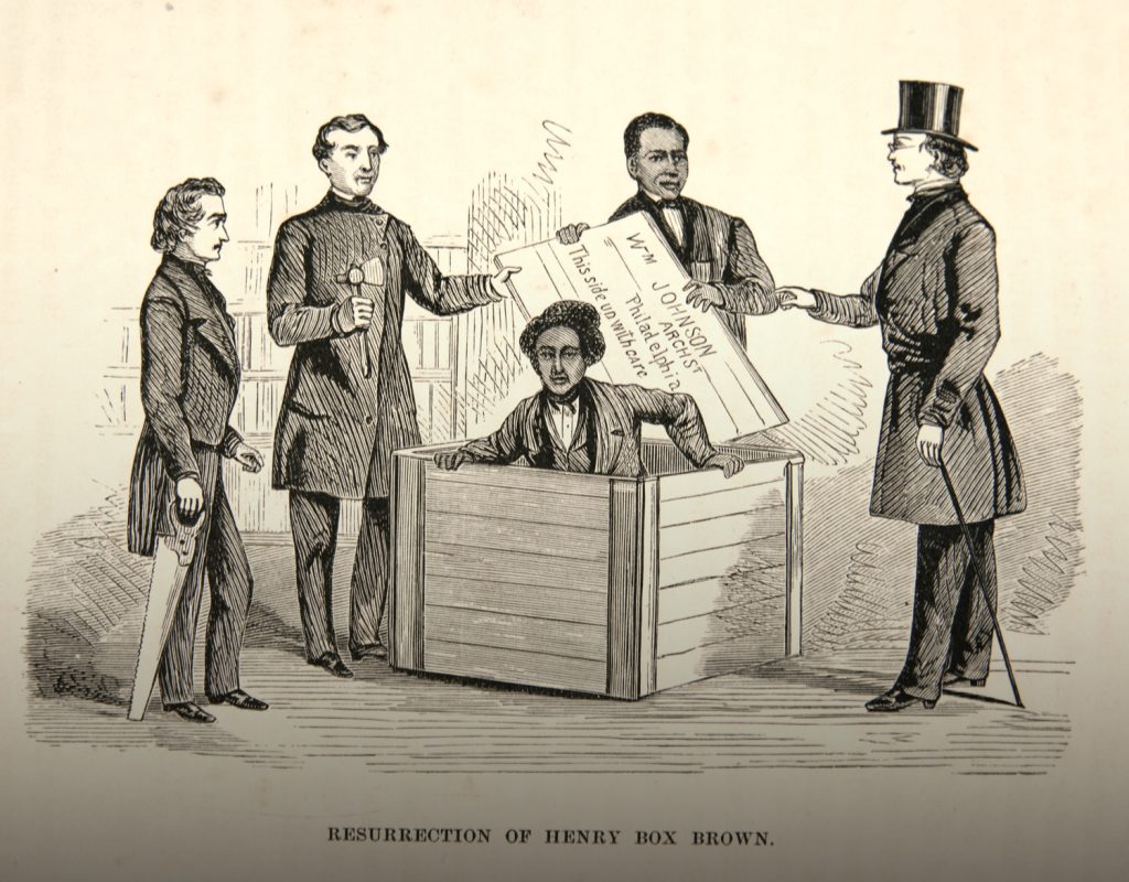 A man in a wooden box surrounded by four other men